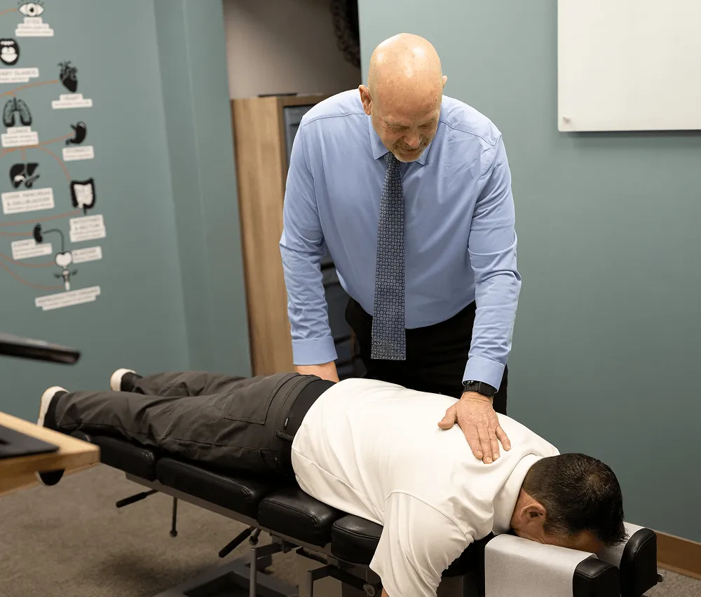 Dr. Ed LeQuire adjusting a patient's lower back at Vitality Chiropractic