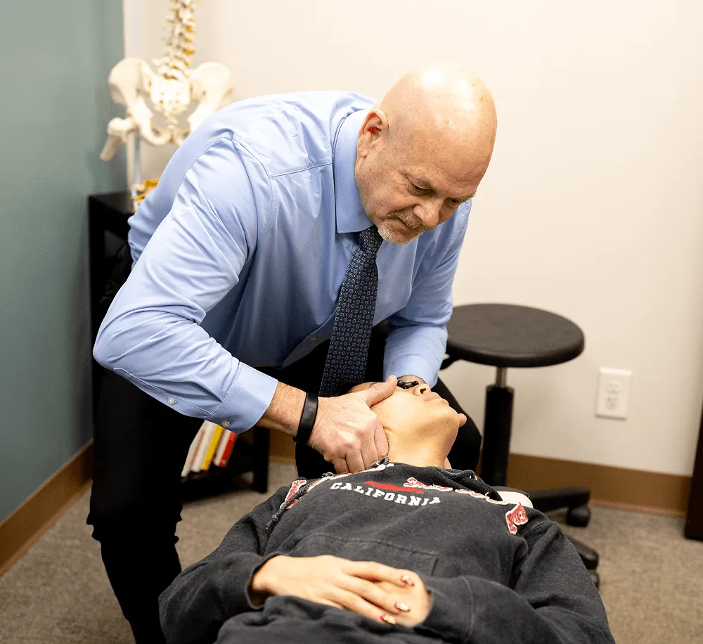Dr. Ed adjusting a patient's neck