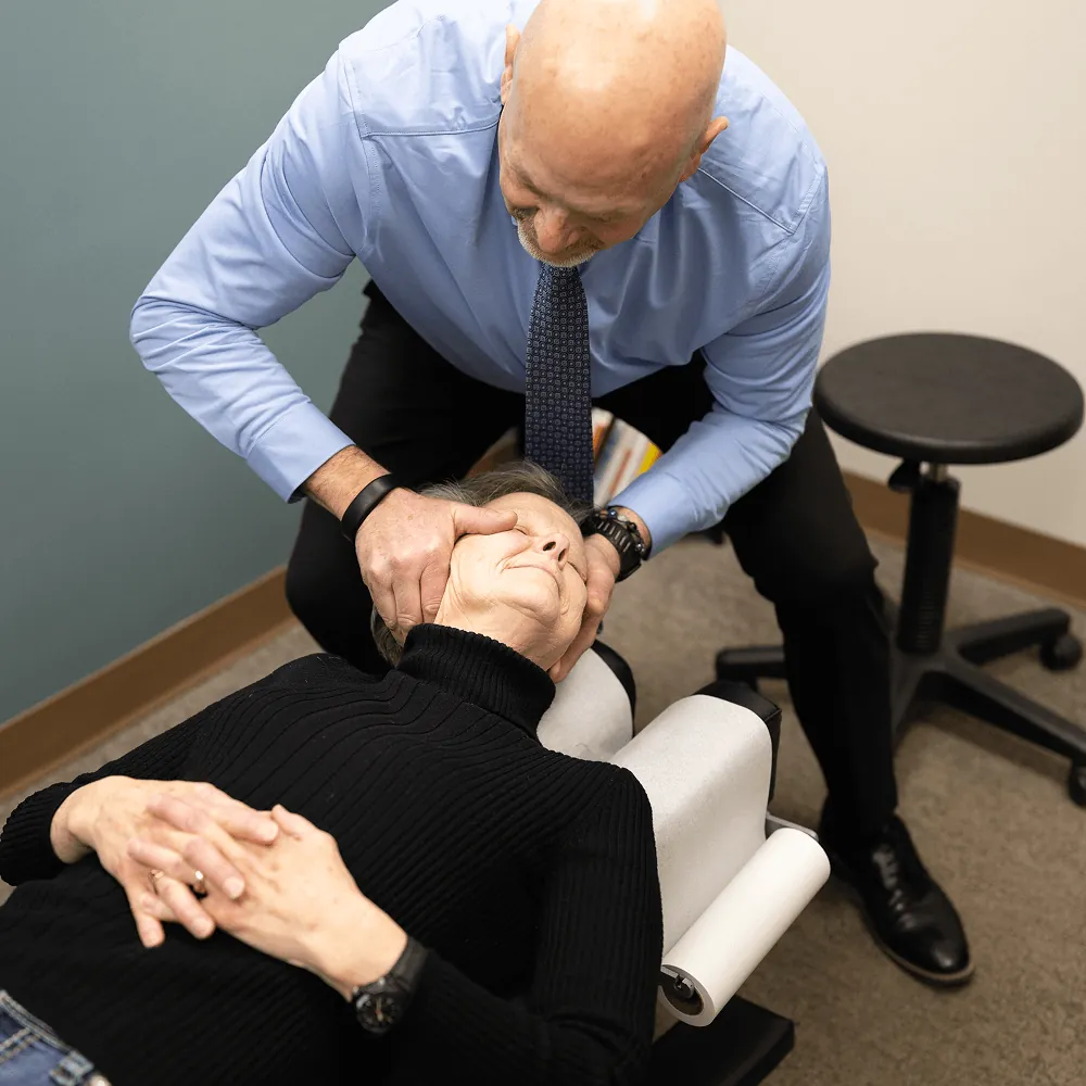 Dr. Ed adjusting a patient's neck