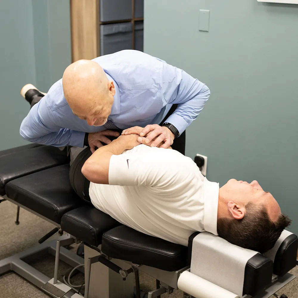 Dr. Ed performing a thoracic adjustment