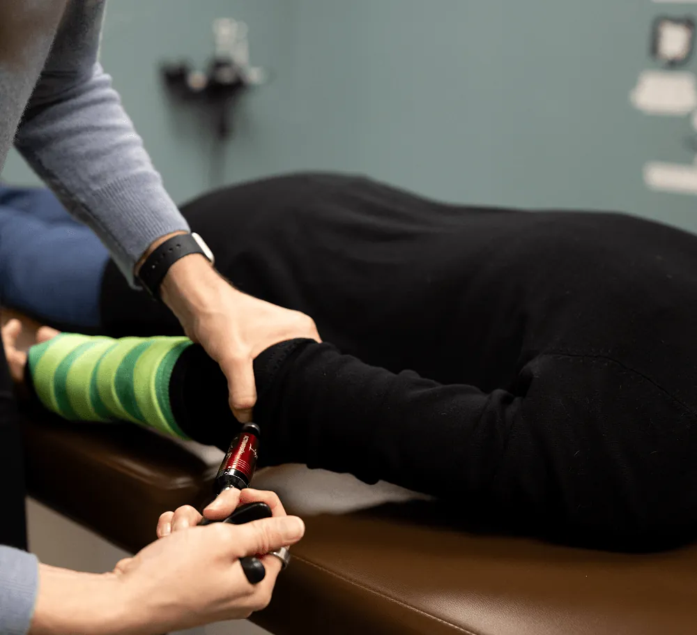 Dr. Stacy adjusting a patient's ankle