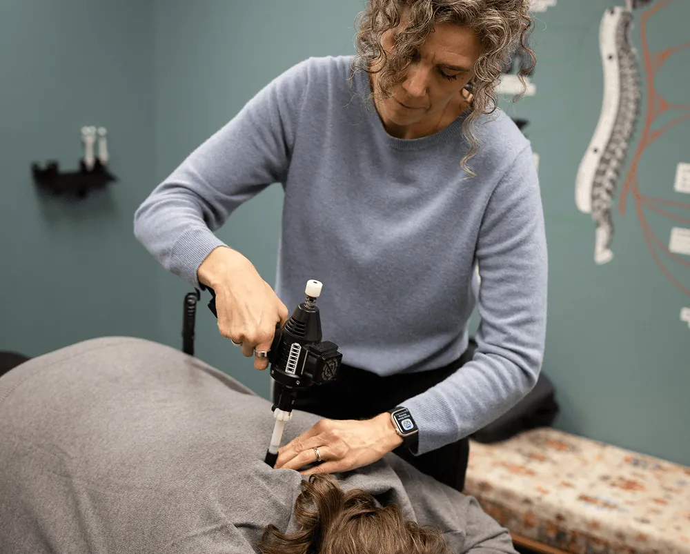 Dr. Stacy using an ArthroStim on a patient's upper back