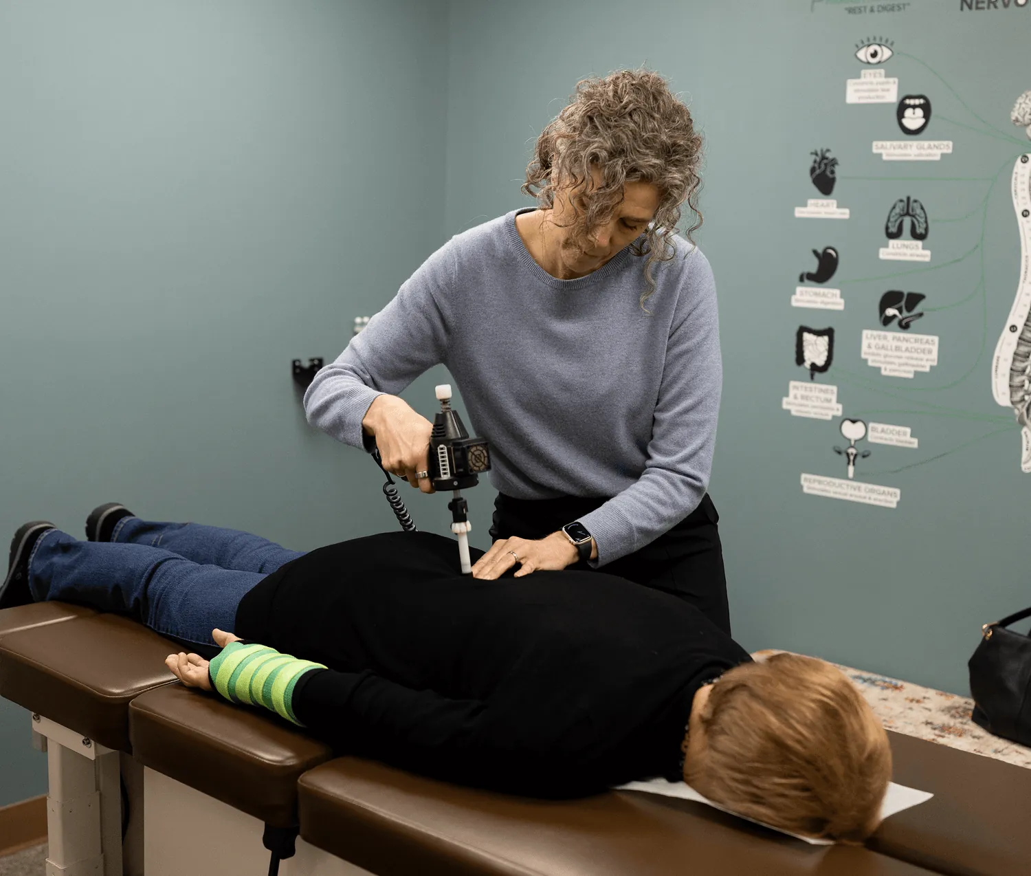 Dr. Stacy performing a gentle instrument-assisted adjustment