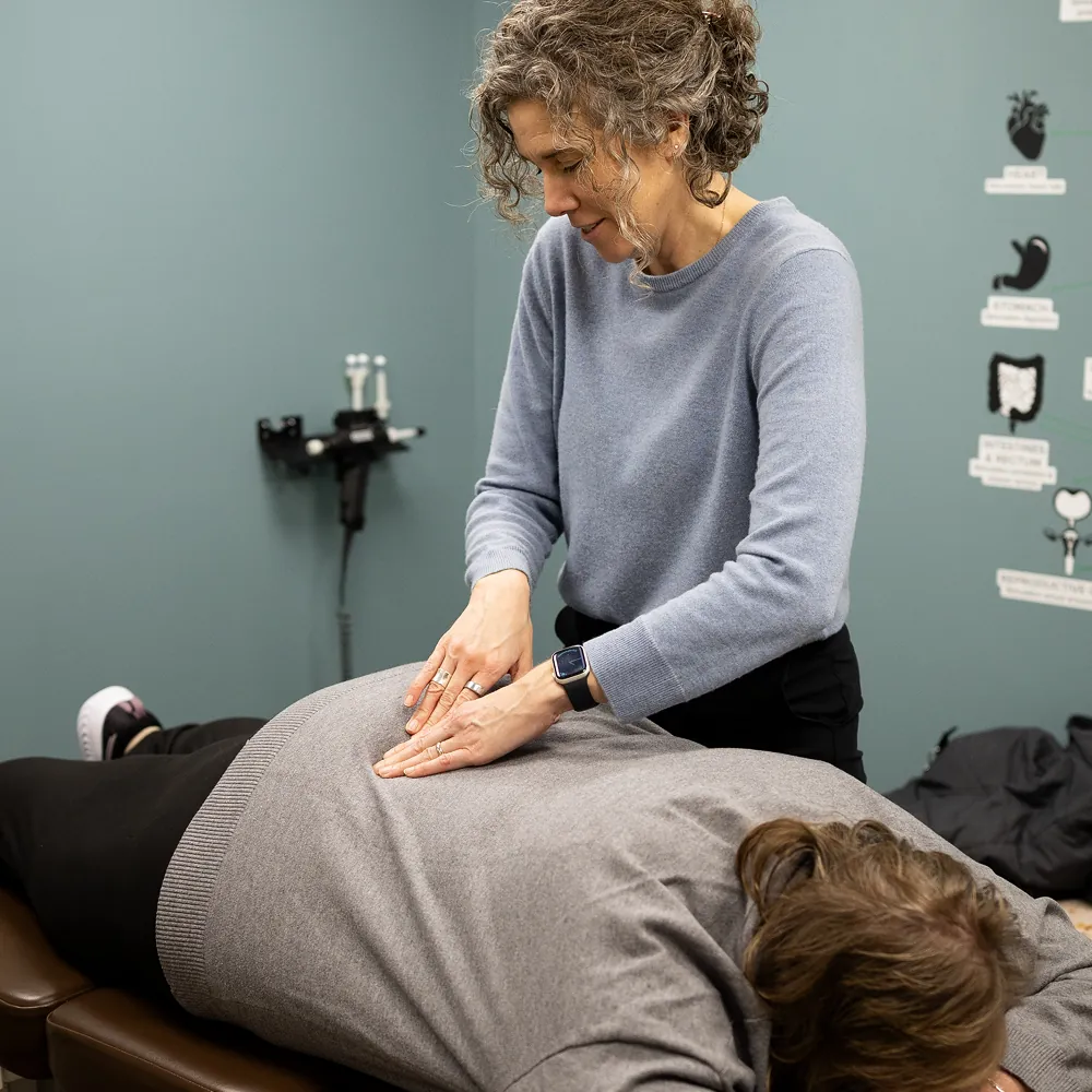 Dr. Stacy assessing a patient's lower back