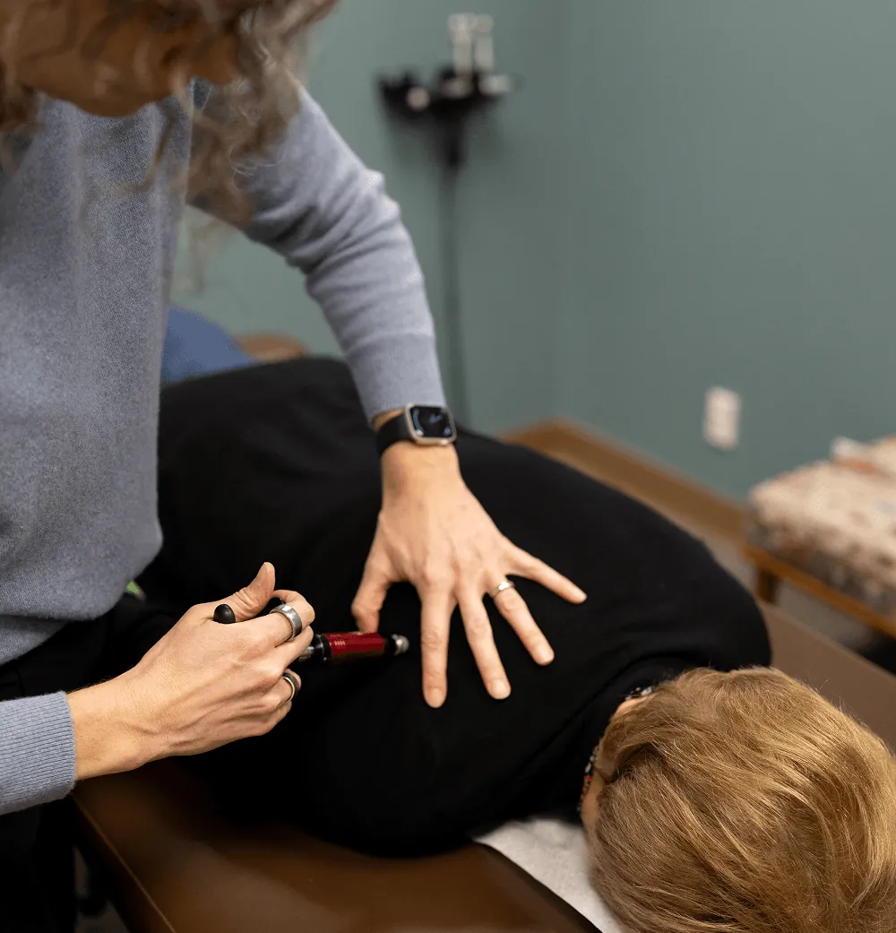 Dr. Stacy adjusting a patient's mid back